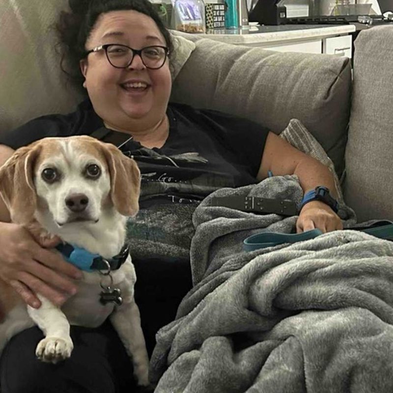 Charisma, co-owner of Awoo Crew Petcare, with a happy client dog